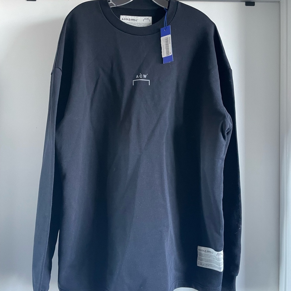 Black pullover by British street culture brand, A-Cold-Wall. Size medium.